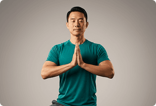 Man standing with his palms pressed together